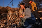 FILE - Ella Venne, left, searches through the remnants of her family's home destroyed by the Eaton Fire in Altadena, Calif., Saturday, Jan. 11, 2025.