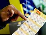 A Mega Millions lottery slip is displayed at Lucky Mart in Chicago on Tuesday, Jan. 10, 2023. After nearly three months of lottery losing, the Mega Millions jackpot has swelled above $1 billion. The odds of winning the top lottery prize are formidable at 1 in 302.6 million.