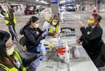 Medical professionals from Oregon Health & Science University load syringes with the Moderna COVID-19 vaccine, on Jan. 10, 2021 in Portland, Ore., at a drive-thru vaccination clinic. The clinic was a partnership between SEIU and Oregon Health & Science University, aiming to vaccinate Oregon's 32,000 home health care workers and their patients.