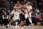 Portland Trail Blazers forward Kris Murray (24) brings the ball to center as Brooklyn Nets guard Keon Johnson (45) defends during the first half of an NBA basketball game, Tuesday, Jan. 14, 2025, in Portland, Ore.