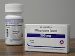 Containers of mifepristone and misoprostol — medications used to end a pregnancy — sit on a table inside of a Planned Parenthood clinic in Fairview Heights, Ill.