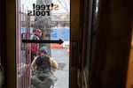 An unhoused person waits for Street Roots to open on March 25, 2020 in Portland, Oregon. The organization is coordinating an outreach program distributing hygiene supplies and coronavirus information to Portland’s unhoused community. 