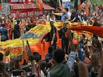 Indian Prime Minister Narendra Modi waves to supporters from atop a vehicle during a road rally held by the Bharatiya Janata Party (BJP) in Bengaluru on May 6, 2023.