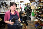 Chris Park at Hillsdale Shoe Repair, June 13, 2024. She's seen business drop off but has found a niche repairing rock climbing shoes.