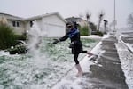 Katarina Bush, 9, throws a handful of snow while heading out on a walk in Northeast Portland on Jan. 14, 2024. Similarly, snow could stick on the valley floor in the Portland metro area overnight, a year later in February 2025.