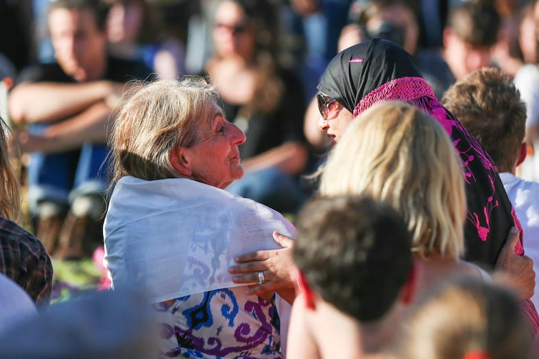 Victim Taliesin Namkai-Meche's mother, left, received embraces from several speakers as they left the microphone.