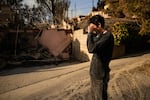 Saturday, Jan. 11: Oliver Braren wipes his eyes as he takes a moment from sifting through the fire-ravaged home of Kaegan Baron's mother in Los Angeles.