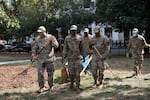 Air National Guard airmen work clearing leaves and debris from McPherson Square Park on August 28, 2025 in Washington, DC.