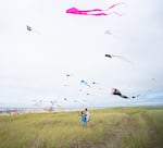 Tiffany Hsu, left, flies a kite with Ryan Carney at the festival. Hsu has been going to the festival since she was a child, and decided to bring her family this year.