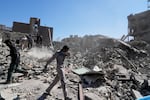 A group of men inspects the ruins of a police station struck Monday amid the U.S.–Israeli military campaign in Tehran, Iran, Tuesday, March 3, 2026.