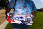 Before the race, George Martin of Purcellville, Va., shows off the Freedom 250 Indy car that he bought. He said that he is a “big car guy” and has a bunch of models of cars.