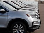 A long line of unsold 2019 Pilot SUVs sits at a Honda BMW dealership in Highlands Ranch, Colo. on Nov. 28, 2018.