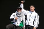 Liam Og, left, and Naoise O Caireallain of the hip hop trio Kneecap perform during the Glastonbury Festival in Worthy Farm, Somerset, England, Saturday, June 28, 2025.