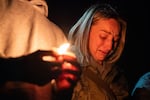 Dara Crawford, a therapist in Bend, cries during a candlelight vigil at Drake Park after three children and a teacher were killed in a shooting at Silver Rail Elementary School in Bend, Ore. on Oct. 15, 2026. 