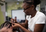Chrystal Thompson, who owns her own salon in Corvallis, braids Aspen's hair at Oak Creek Youth Correctional Facility in Albany, Ore., on June 30, 2026. The natural hair care program at the facility allows students to get their natural hair care license, which they can use to get work once released.