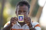 Dayaratne Halambage shows a portrait of his daughter who died during the 2004 Indian Ocean tsunami at a memorial of the 20th anniversary of the calamity in Peraliya, Sri Lanka, Thursday, Dec. 26, 2024.