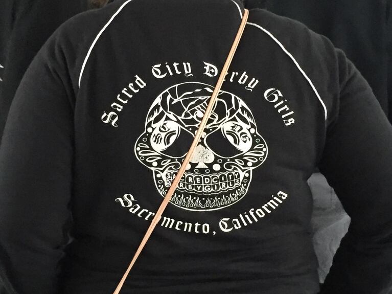 A fan displays her Sacred City Derby Girls jacket.
