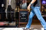 A hiring sign is displayed in front of store at the Charles Tyrwhitt at the Tysons Corner Center mall on August 22, 2024, in Alexandria, Virginia.