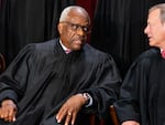 Associate Justice Clarence Thomas, left, talks to Chief Justice John Roberts during the formal group photograph at the Supreme Court in Washington, D.C., on Oct. 7, 2022.