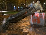 Protesters in Portland toppled multiple statues, including this one of President Abraham Lincoln, on Sunday, Oct. 11, 2020, during an event they called "Indigenous People's Day of Rage."