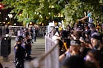 Protesters face police officers along a fence in downtown Portland on June 2, 2020.