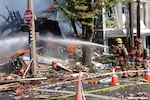 Portland firefighters douse the site of a gas explosion in Northeast Portland, Oct. 19, 2016.
