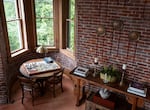 Part of the living room extends into the castle's tower bay, where the Grouts enjoy working together on puzzles. 