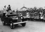 Queen Elizabeth II and Prince Philip wave from an open Land Rover to a crowd of schoolchildren at a rally held in Nigeria in 1956. The country would gain independence four years later.