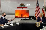 President Donald Trump listens as California Gov. Gavin Newsom speaks during a briefing at Sacramento McClellan Airport, in McClellan Park, Calif., Monday, Sept. 14, 2020, on the western wildfires.