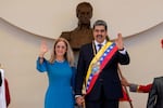 FILE - Venezuelan President Nicolas Maduro and his wife Cilia Flores wave after his swearing-in ceremony for a third term at the National Assembly in Caracas, Venezuela, on Jan. 10, 2025.