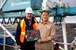 Port of Portland executive director Curtis Robinhold presents captain Kim Ex Soo with a celebratory plaque aboard the first SM Line vessel in Portland, Ore., on Tuesday, Jan. 14, 2020.