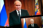 Russian President Vladimir Putin is seen on monitors as he addresses the nation on Saturday after Yevgeny Prigozhin, the owner of the Wagner Group military company, called for armed rebellion.