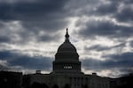 FILE - The Capitol in Washington, is framed by early morning clouds, March 19, 2024. Congress has until midnight Friday to come up with a way to fund the government, or federal agencies will shutter. It's up to each federal agency to determine how it handles a shutdown, but there would be disruptions in many services.