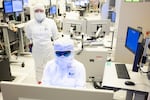 Intel employees in clean room "bunny suits" work at Intel's D1X factory in Hillsboro, Oregon. The company plans to modernize operations in Oregon with the help of federal funding announced Wednesday, March 20, 2024, by the Biden administration.