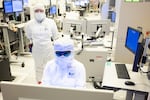 Intel employees in clean room "bunny suits" work at Intel's D1X factory in Hillsboro, Oregon. The grand opening of D1X's "Mod3" in 2022 will provides Intel engineers with an additional 270,000 square feet of clean room space to develop next-generation silicon process technologies. 