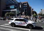 A local police vehicle drives past a demonstration against the deployment of the National Guard and increased immigration raids in Washington, D.C., in late August.