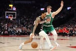 FILE - Portland guard Anfernee Simons drives to the basket on Boston forward Baylor Scheierman March 23, 2025, in Portland, Ore. The Blazers could fetch more than $3 billion in a sale; the Celtics were sold for $6.1 billion.