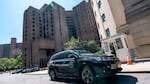 A New York Medical Examiner's car is parked outside the Metropolitan Correctional Center where financier Jeffrey Epstein was being held in New York. Epstein committed suicide in prison while awaiting trial.