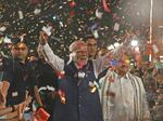 India's Prime Minister Narendra Modi flashes victory signs as he arrives at the Bharatiya Janata Party (BJP) headquarters to celebrate the party's win in the country's general election, in New Delhi, on Tuesday.
