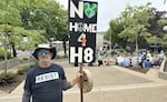 Local activist Tom Adair stands with his protest sign outside the Eugene Federal Building on July 4, 2026. the flip side shared the names of Renee Good, Keith Porter Jr., and Alex Pretti, U.S. citizens who were killed by ICE personnel.