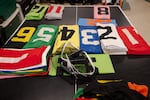 Program numbers, found on each race horses’ saddlecloth, are laid out on a table in the jockey quarters of Churchill Downs in Louisville, Ky., on April 30, 2025.