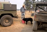 Pat Nogle calls friends and neighbors for help as he prepares to defend his cattle from fires. 
