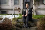 Joe Dibee sits on steps leading to his family's home on Wednesday, February 17, 2021, in Seattle.