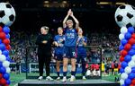 OL Reign forward Megan Rapinoe acknowledges the crowd as coach Laura Harvey (from left), defender Lauren Barnes, and midfielder Jess Fishlock stand nearby during a ceremony honoring her career, after the team's NWSL soccer match against the Washington Spirit on Friday.