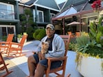 Ken Perez, a recent graduate of Mt. Hood Community College and a resident at the affordable student housing complex Abigail Court, enjoys spending time in the building’s courtyard with his emotional support dog, Tila, on July 29, 2025.