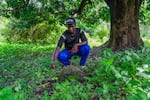 Kansala, Guinea-Bissau (September 24, 2024) - Abulai Sane, a son of Tombon Sana, who is the guardian of the Kansala site, shows the area where griots used to sit and perfrom their songs, which told the history of the area.