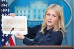 White House press secretary Karoline Leavitt holds up photos of the planned new White House ballroom during a press briefing at the White House on July 31. According to the White House, the new White House ballroom will be approximately 90,000 square feet and cost about $200 million.