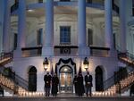 L-R: President Joe Biden, first lady Jill Biden, Vice President Kamala Harris and Doug Emhoff, hold a moment of silence and candelight ceremony in honor of those who lost their lives to the coronavirus outside the White House on Monday evening.