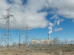 Power lines lead into the coal-fired Intermountain Power Plant outside Delta, Utah. The plant, which is getting new turbines that can burn natural gas and hydrogen, is at the center of an ambitious project to cut greenhouse gas emissions.