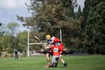 Players clash during a 2017 pub league hurling match in Portland.